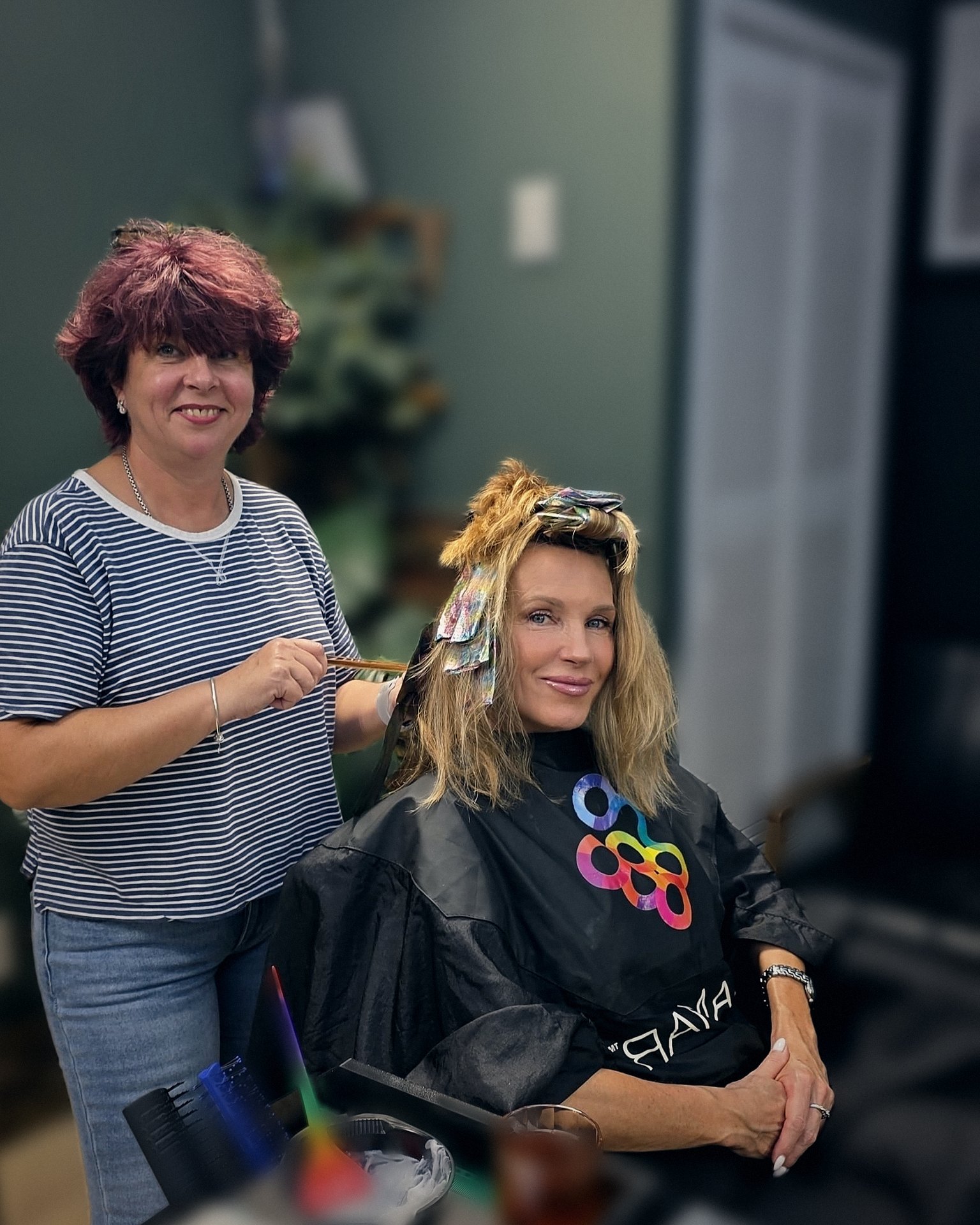 Rita putting highlights in a client’s hair at Best Barber Shop