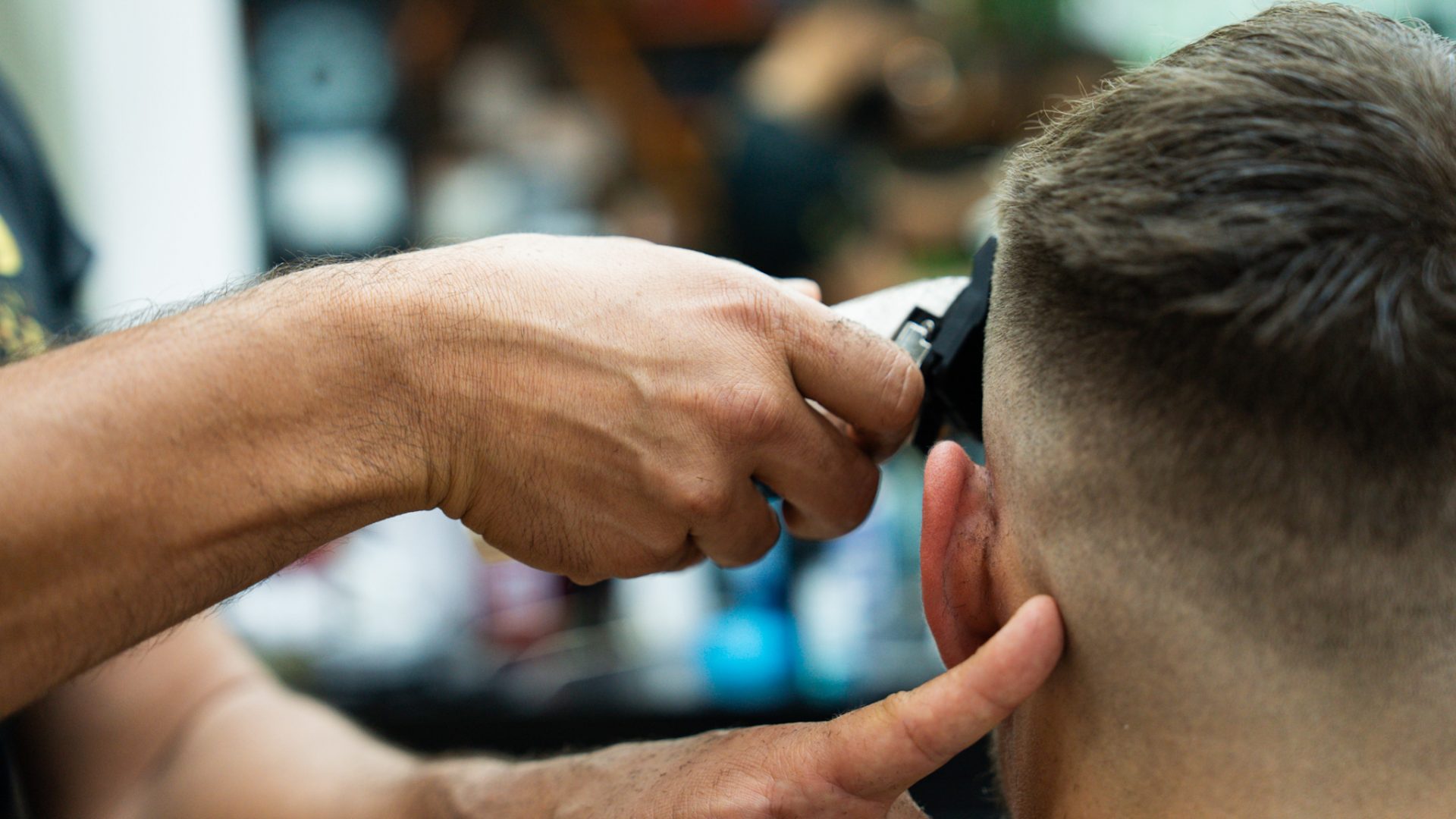 Barber cleaning up a client’s neckline