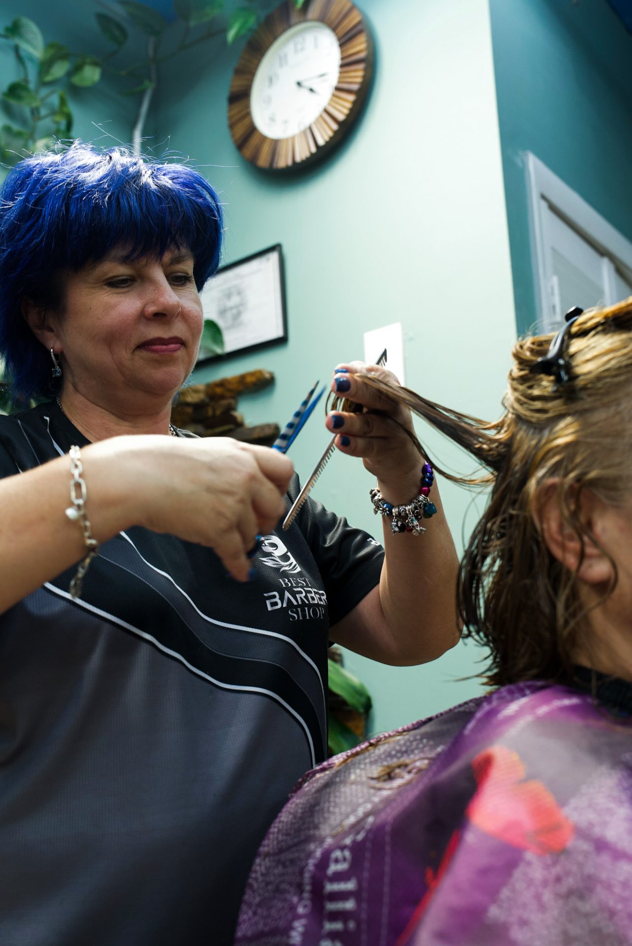 Stylist cutting a woman’s hair